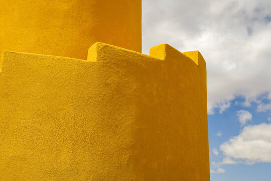 yellow ziggurat wall and blue sky