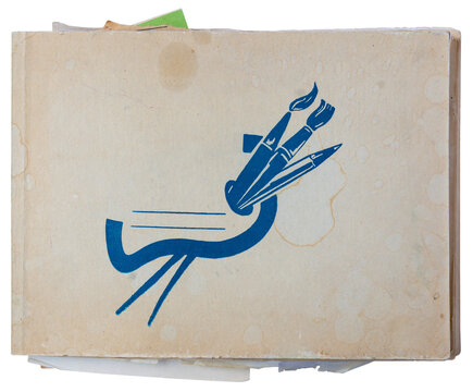 Vintage stained beige sketchbook with blue paintbrush and pencil symbol on worn cover isolated on white
