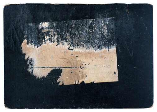 Worn black vintage hardcover book cover with a large torn paper label, glue residue and scratched cloth surface isolated on a white background