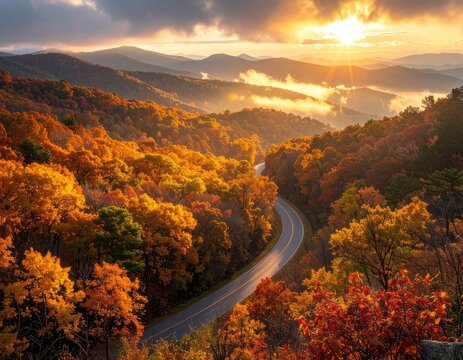 Scenic mountain road winds through vibrant autumn foliage under a golden sunset.