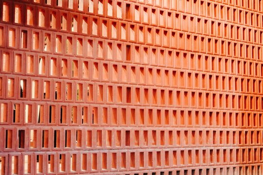 Geometric pattern of orange terracotta brick wall texture