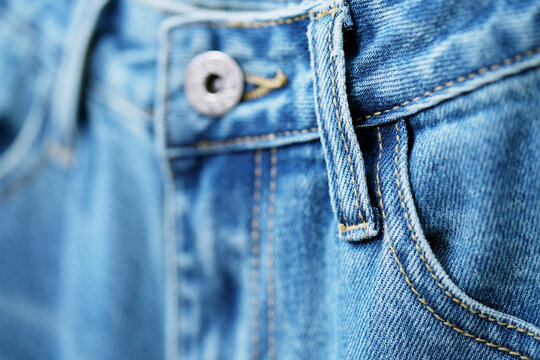 Front pocket and small pocket blue jeans pants with seam of fashion design. close up, macro. concept business, shopping, sale. Design detail, button and seams, copy space