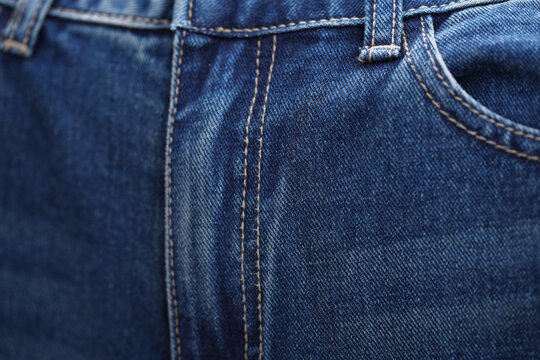 Front pocket and small pocket blue jeans pants with seam of fashion design. close up, macro. concept business, shopping, sale. Design detail, button and seams, copy space