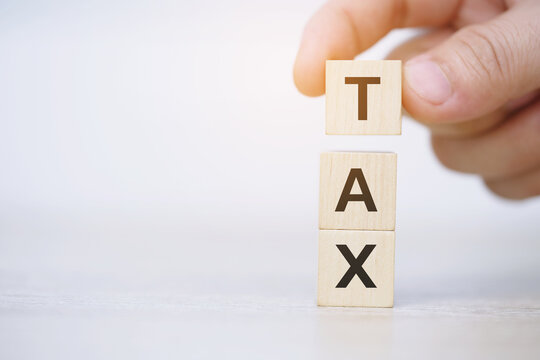Tax Concept. Wooden Blocks with different heights of money heaps and Coins with the Word. Personal Income, Corporate, Financial Research, payment.	
