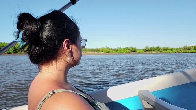 Woman Looking at Munda&uacute; River Mangroves from a Boat