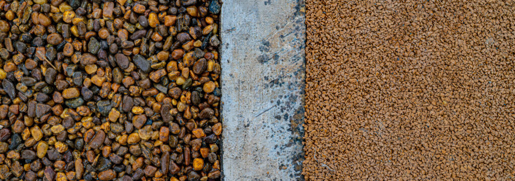 Small brown gravel pebbles next to gray concrete surface showing texture contrast, landscaping and construction material concept