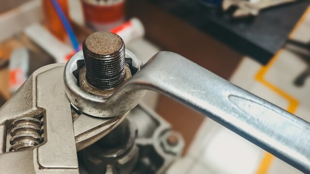 Wrench and socket tightening bolt close-up