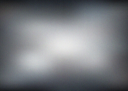Sleek monochromatic grayscale gradient texture with a subtle light center creating a minimalist abstract design