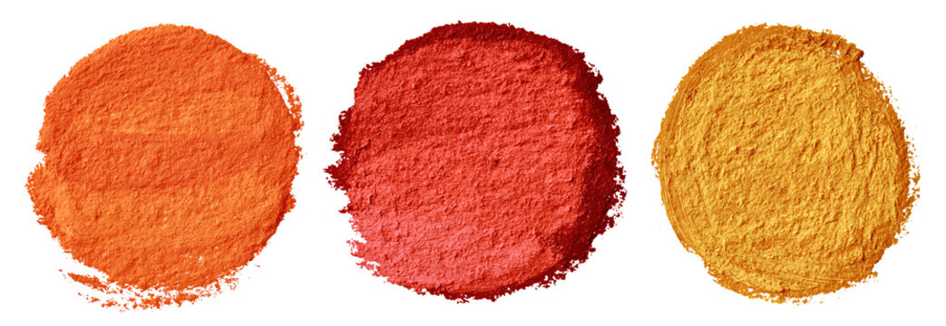 Three piles of colored powder pigment on transparent background