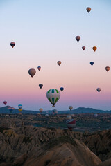 Hot air balloons soaring over the enchanting landscapes of Cappadocia, Turkey at sunrise © Fokke Baarssen