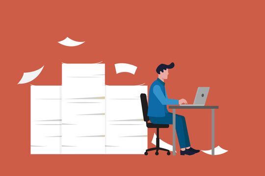 Overwhelmed man working on his laptop at a desk under the pressure and looming deadlines