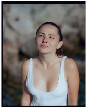 Portrait of woman in white swimsuit on the beach in Greece, film 
