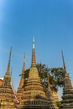 Buddhist Pagodas Stand Tall Under Clear Blue Sky in Thailand