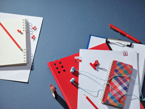 Creative workspace setup with colorful stationery and headphones