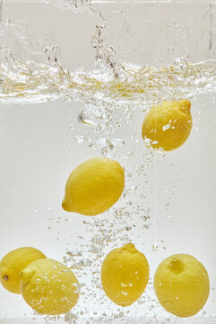 Lemons Floating in Refreshing Water with Bubbles