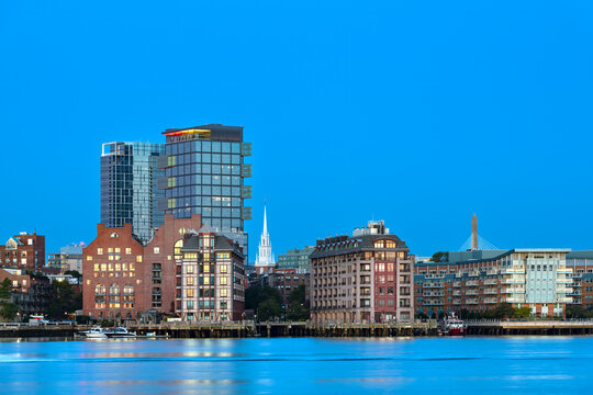 Beautiful view of the North End skyline of Boston with the Old North Church spire at dawn, seen across the Inner Harbor from East Boston.