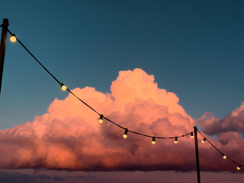 String Lights Against a Surreal Sunset Sky