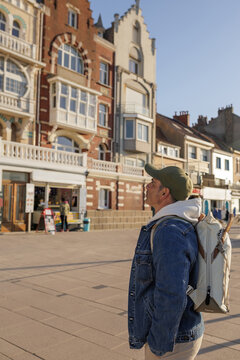 Man with backpack looking at beautiful historic building facades