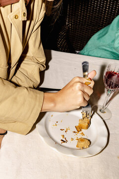 Hand cutting cheesecake dessert after home dinner party