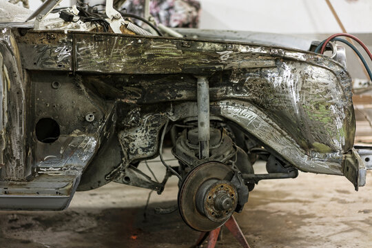 Stripped Bare Metal Car Chassis and Front Suspension under Restoration