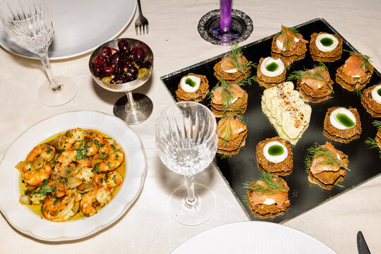 Seafood dinner spread with appetizers and salmon crackers