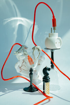 Creative arrangement of objects with red electric cable in studio