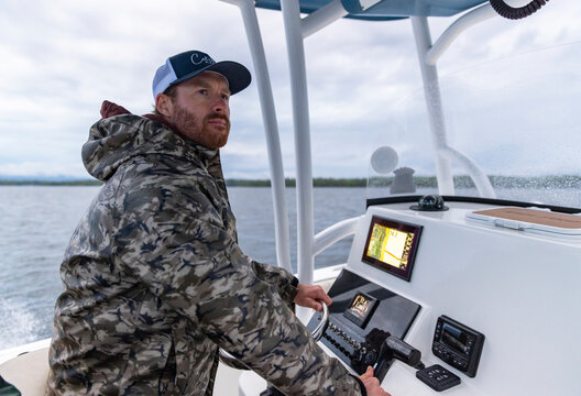 Confident Boat Fisherman  smile at helm Fish finder