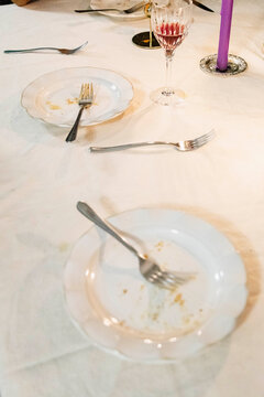 Empty dessert plates after candlelit home dinner party