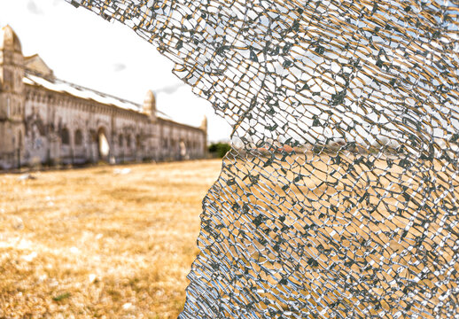 Detailed image of a broken and cracked tempered glass window.