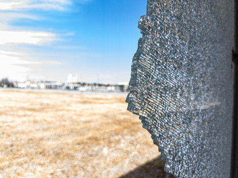 Detailed image of a broken and cracked tempered glass window.
