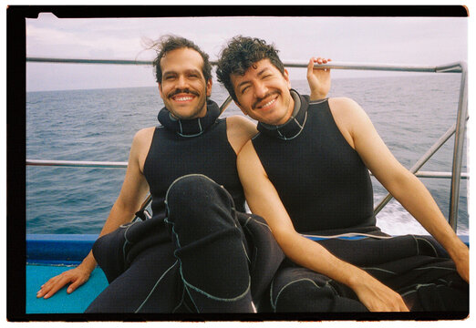Scuba diving friends relaxing on boat after ocean adventure