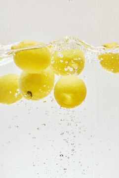 Lemons Floating in Refreshing Water with Bubbles
