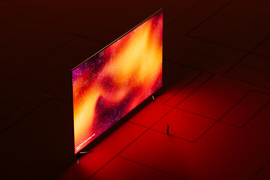 A man stands in front of a large digital screen