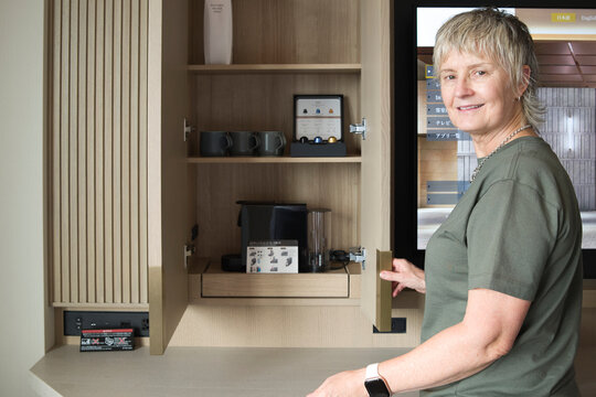 Woman Prepares Coffee in Hotel Room at Morning Time