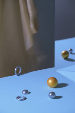 Abstract composition with spheres, rings, and reflective surfaces