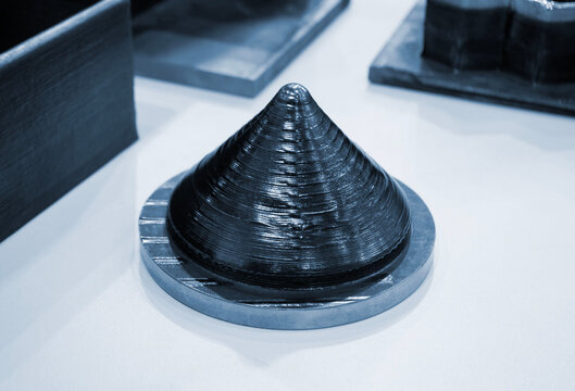 Model conical shape manufactured industrial 3D metal printing. Additive manufacturing. Metal alloy. Object printed on 3D printer from metal. Layer-by-layer deposition of metal thread. 3D printing