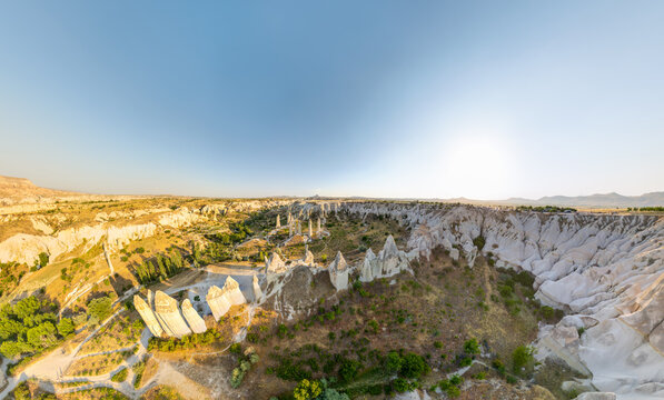 Goreme, Nevsehir, Turkey. Wide aerial view of Love Valley capturing the iconic phallic rock formations, surrounding canyon walls and Lovers Hill sunset viewpoint. Aerial view.