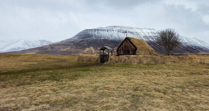 Grafarkirkja turf church with snowy mountains. Iceland, icelandic landscape