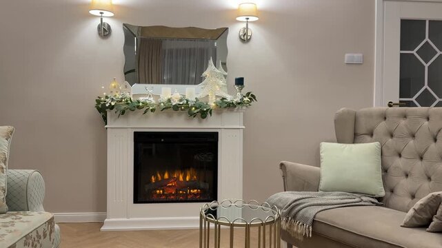 Horizontal video of a cozy modern living room with a white handmade electric fireplace, elegant armchair, and beautiful Christmas decor