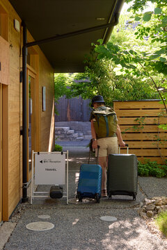 Traveler Arrives at Hotel With Luggage Near Reception Area