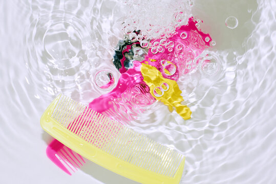combs floating in water with bubbles and light.