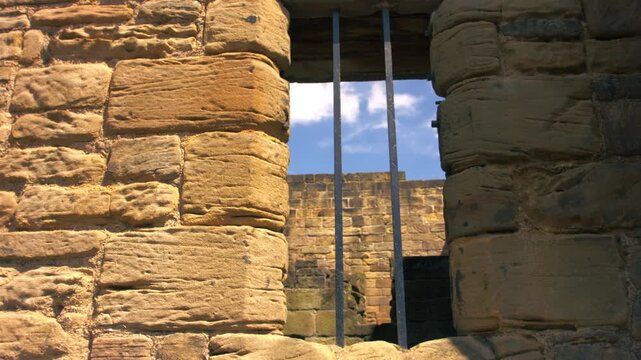 Prison bars on a stone wall