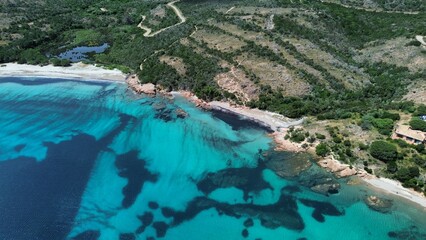 Obraz premium Aerial View of Rocky Coastline and Turquoise Sea in Corsica
