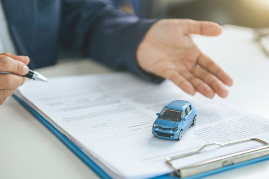Car insurance consultation with vehicle model and policy documents evaluating coverage options managing risk protection and supporting informed automotive decisions