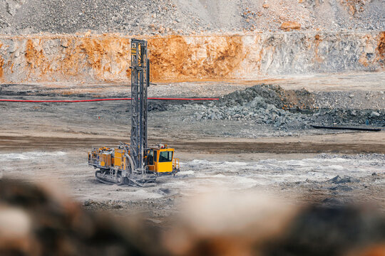 Drilling rig in open pit quarry for industrial background and banner design showcasing heavy excavation equipment