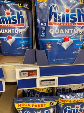 Dishwasher detergent packages on store shelf, showing prices and quantity
