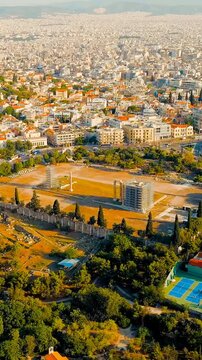 Vertical video. Athens, Greece. Olympeion, Temple of Olympian Zeus - the largest temple of Ancient Greece, built from the 6th century BC. e. until the 2nd century A.D. e. Summer. Drone footage, Point