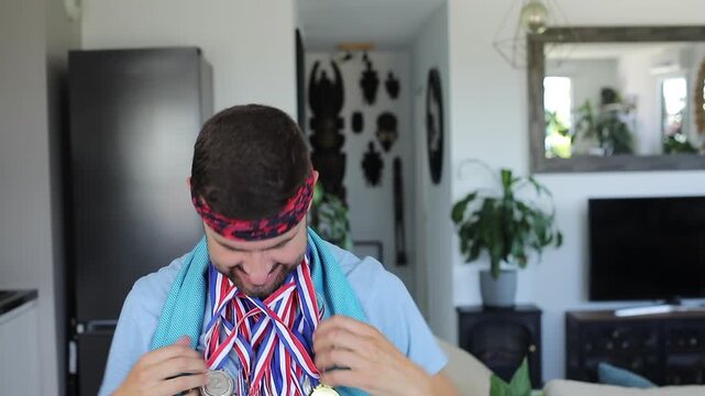 Sporty man showing many medals