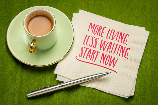 More Living. Less Waiting. Start Now. &ndash; inspirational handwritten note on a napkin with coffee and pen, encouraging action, purpose, and living life without delay.