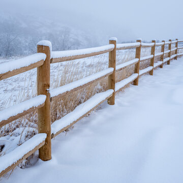 wooden fence in winter scenery of Colorado foothills